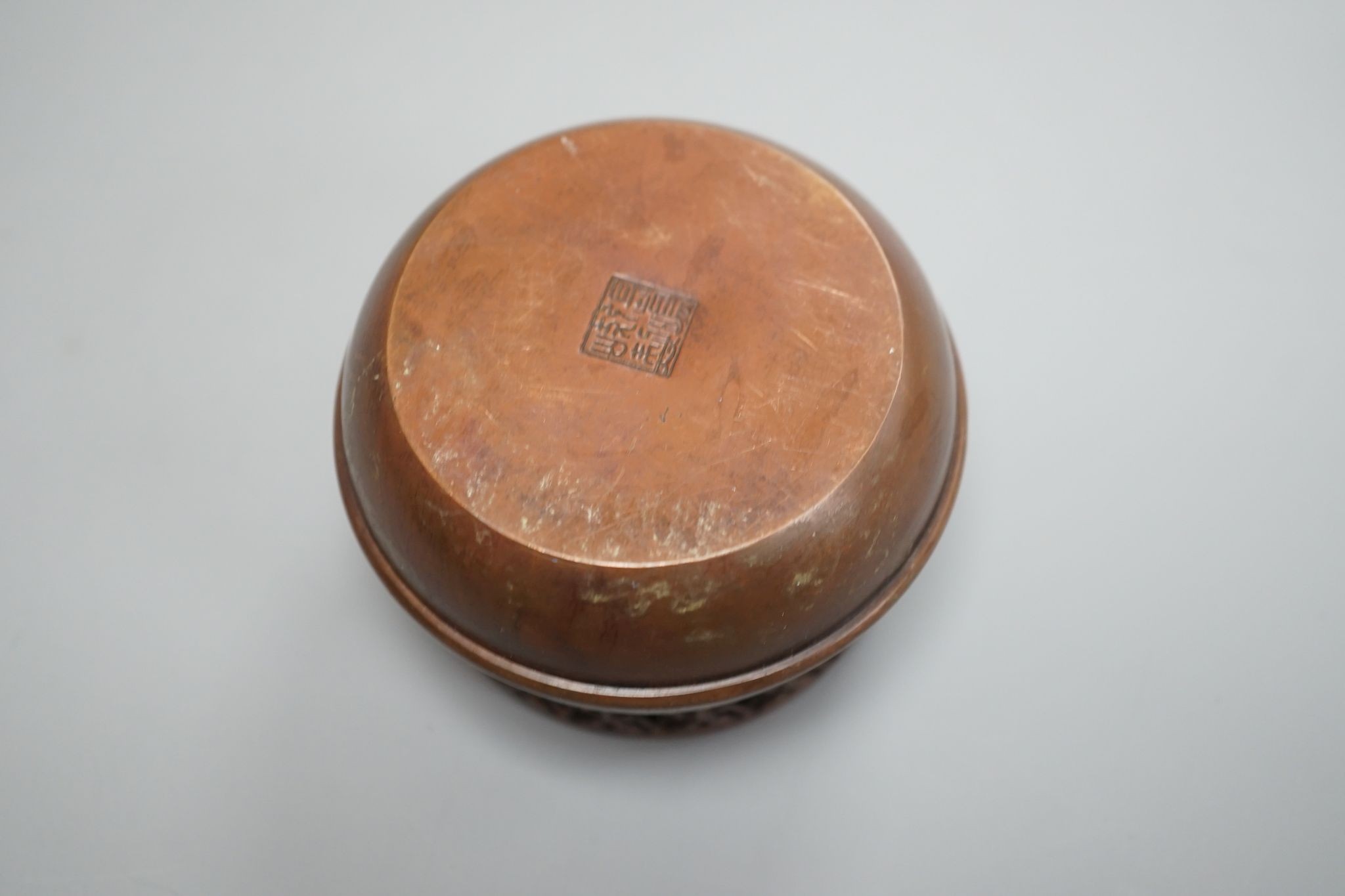 A Chinese bronze hand warmer, signed Zhang Mingqi 8cm diameter